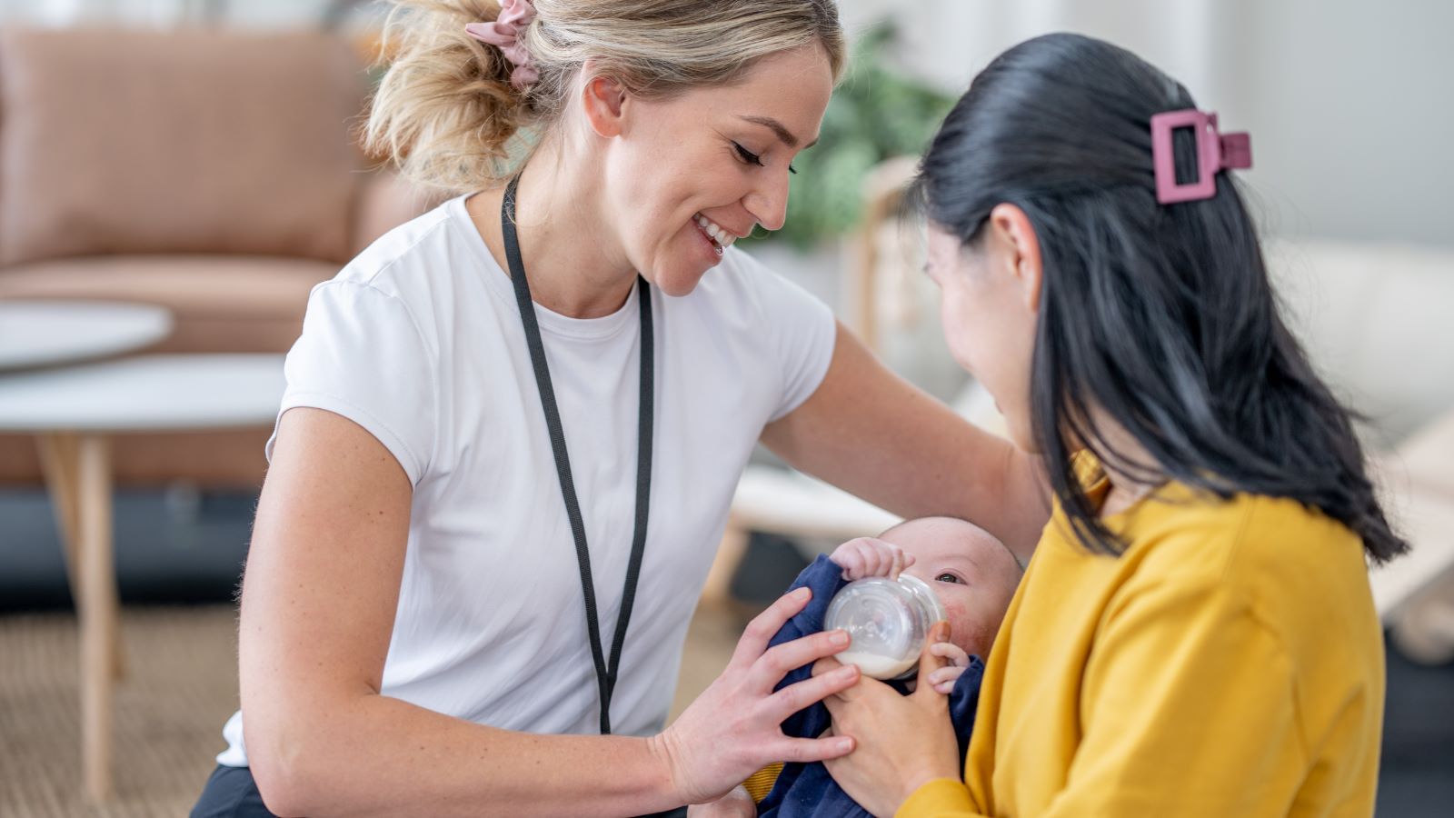 lactation consultant helping a mother and baby