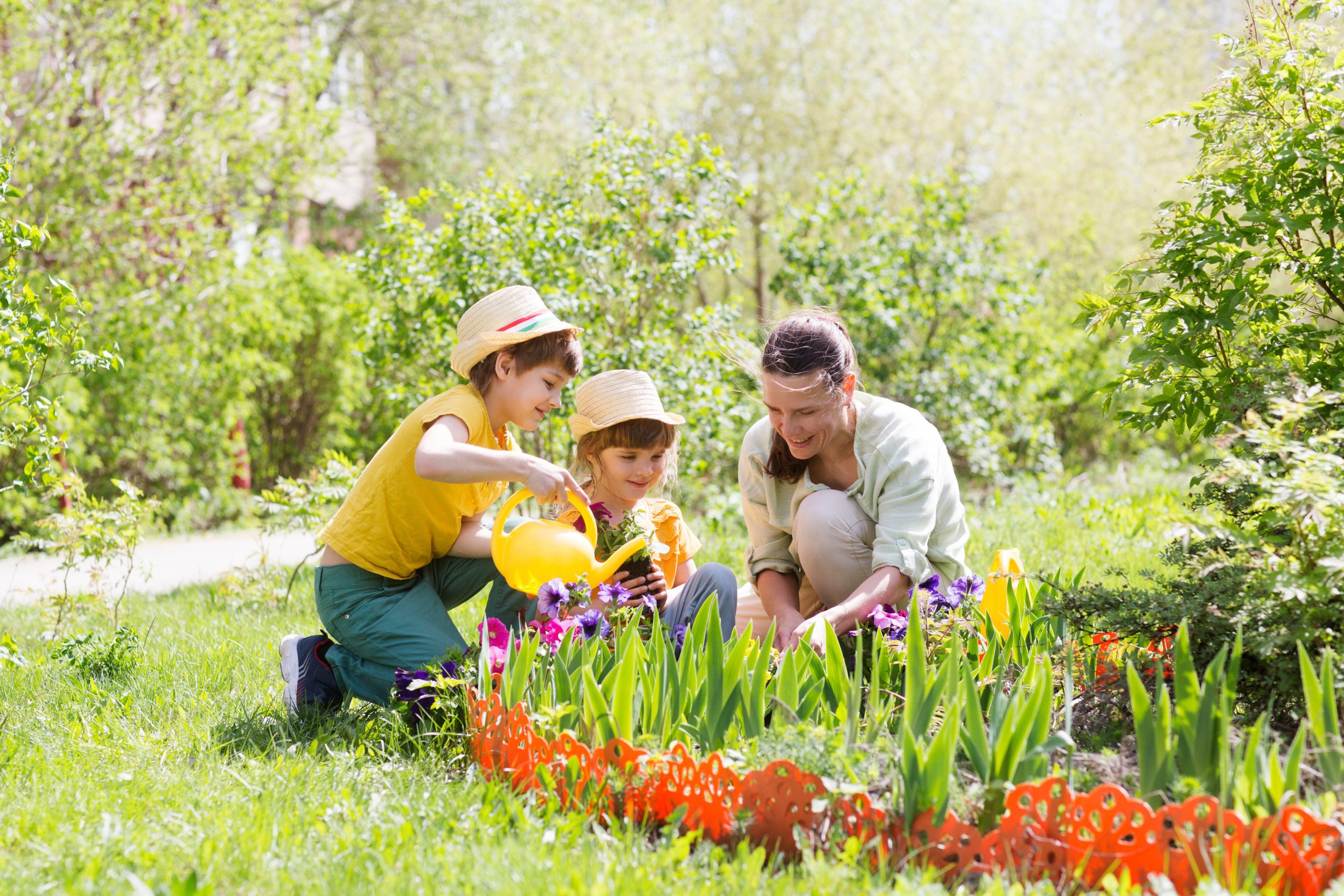 Smiling family gardening on a sunny day