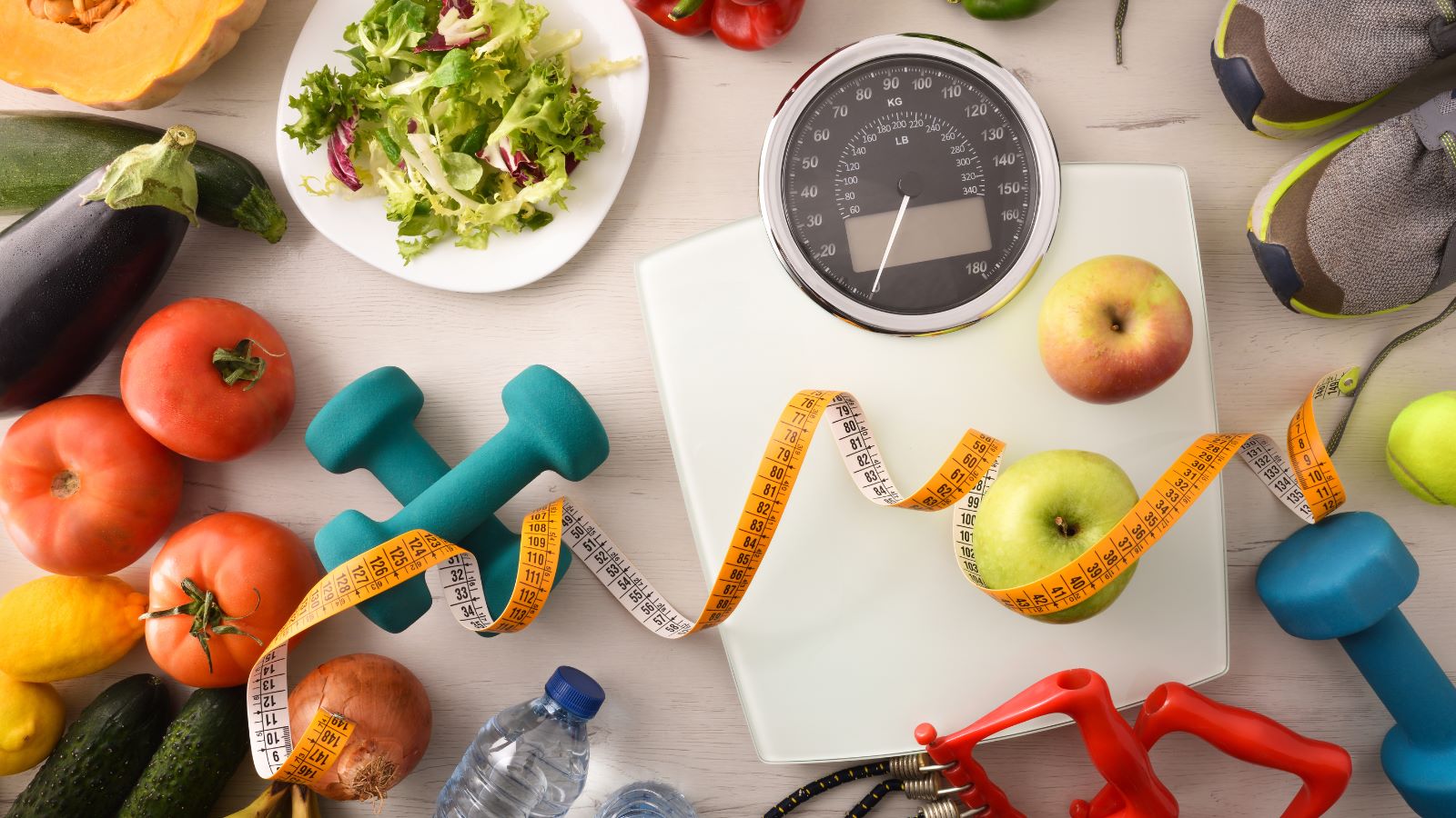 healthy foods and scales and weights on a table